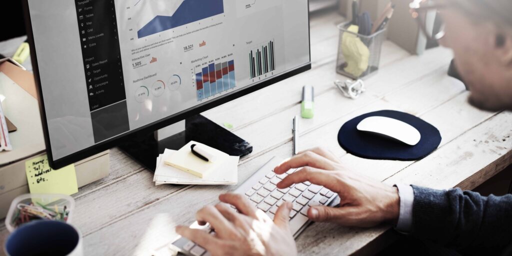 Man sitting at computer review the analytics from his website