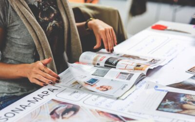 Woman flipping through the pages of a magazine that is perfect bound.