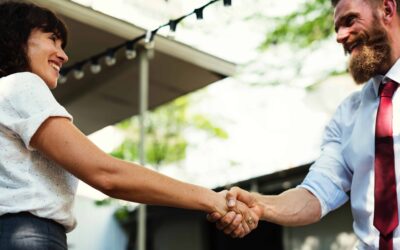 Two business people shaking hands outside