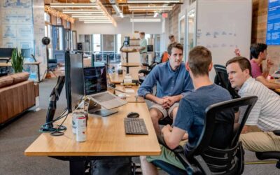 Employees in an open space office discussing work