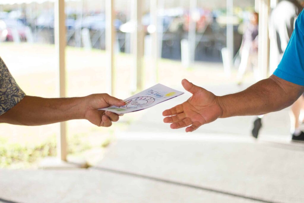 A person passing out company brochure