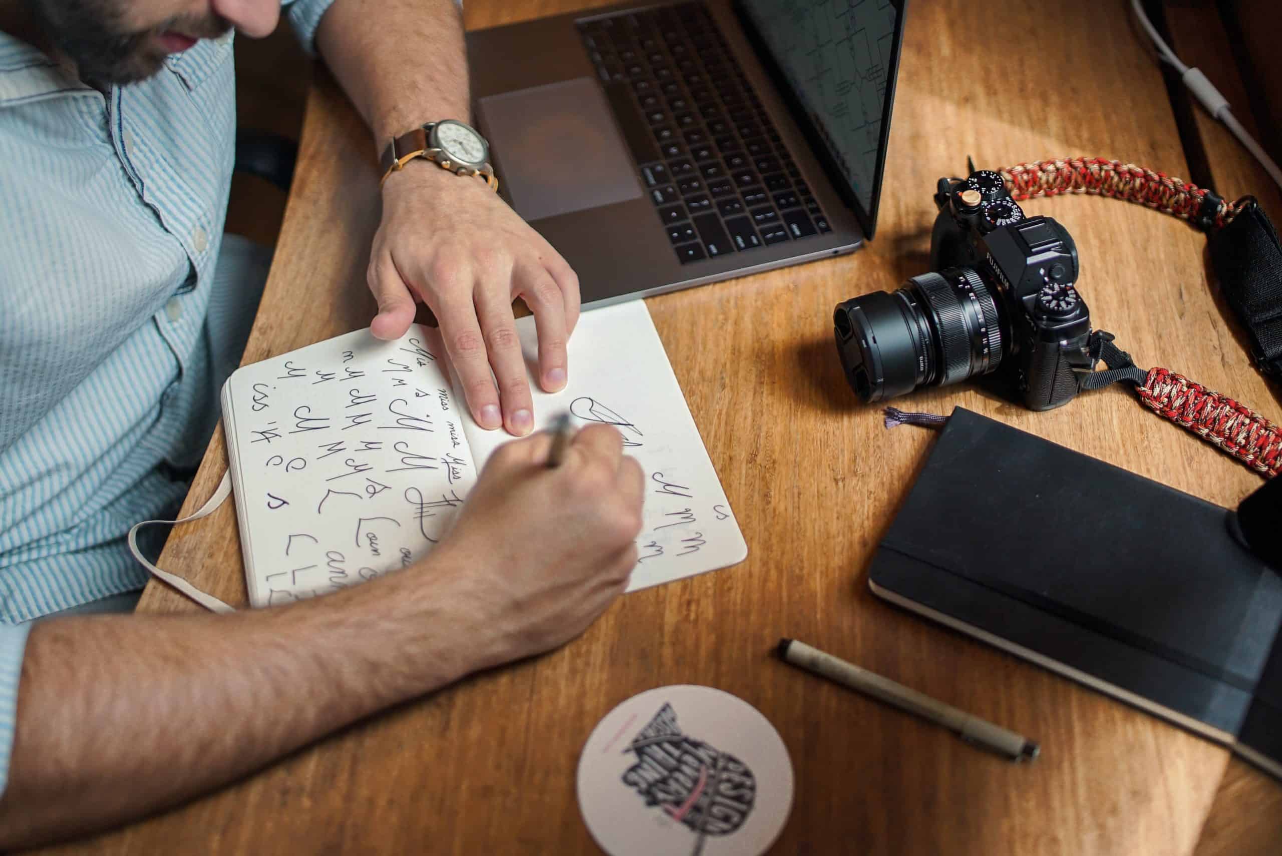 Artist practicing letter writing in a notebook