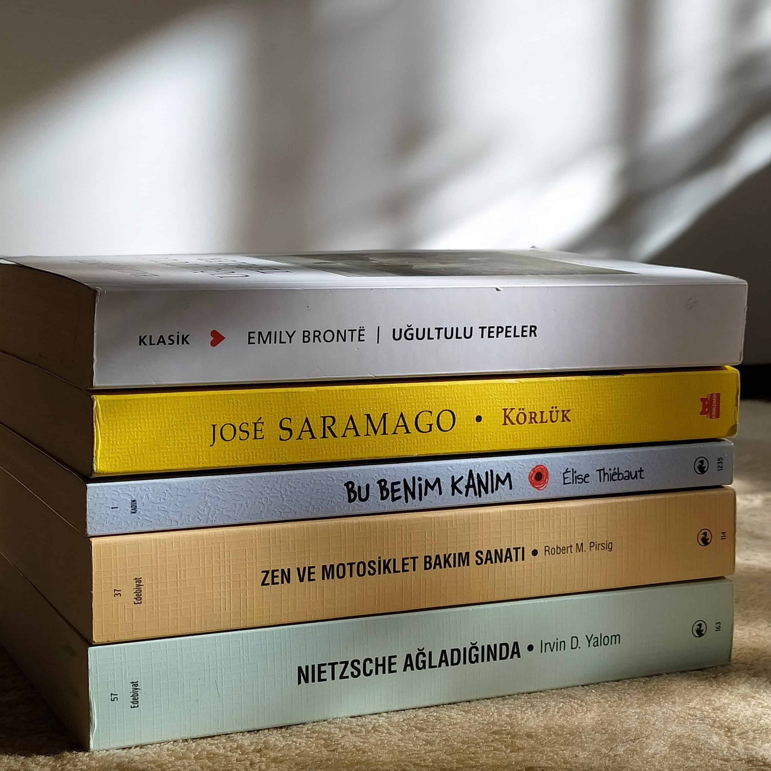 Stack of paperback books on a carpet