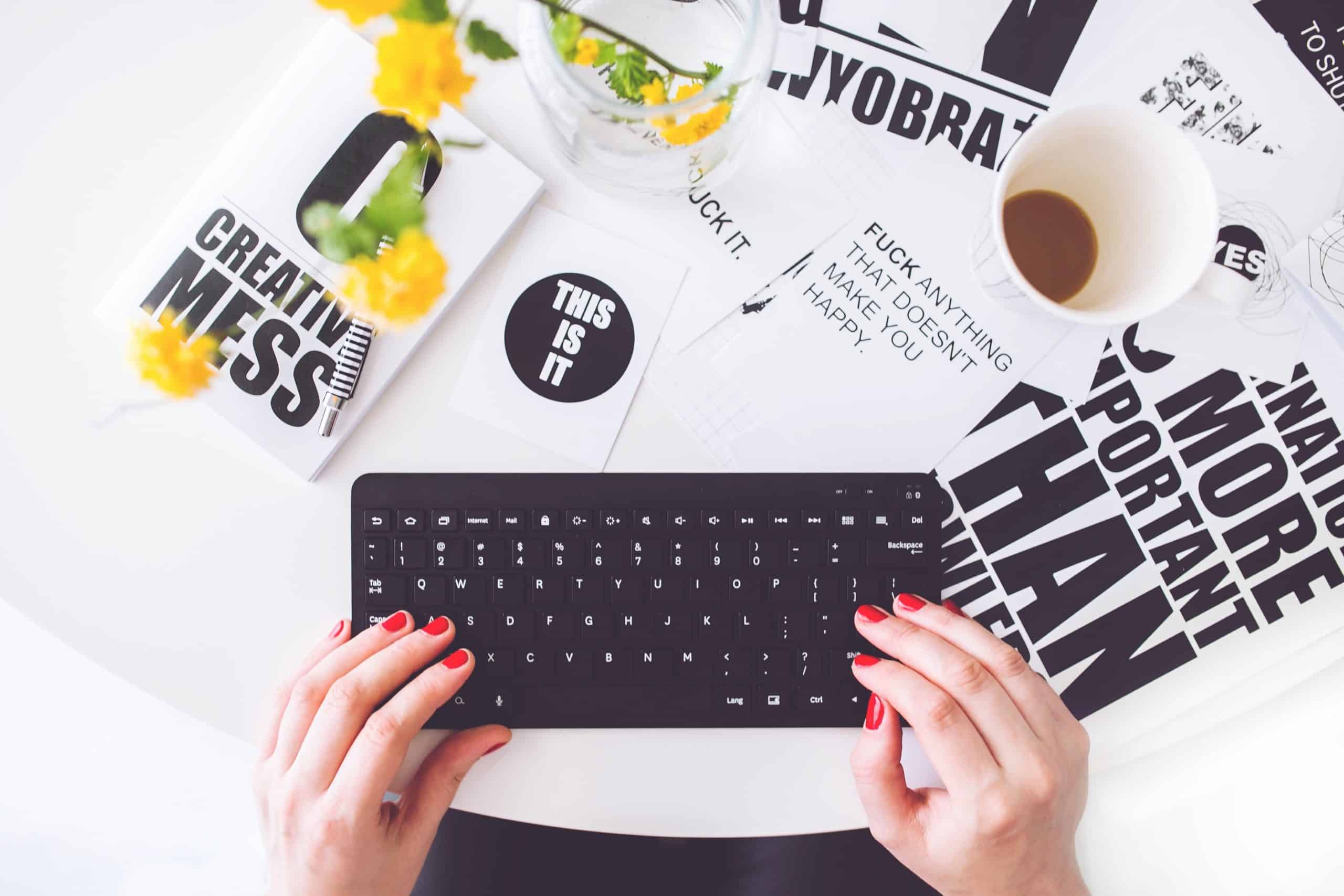 girl typing on black keyboard