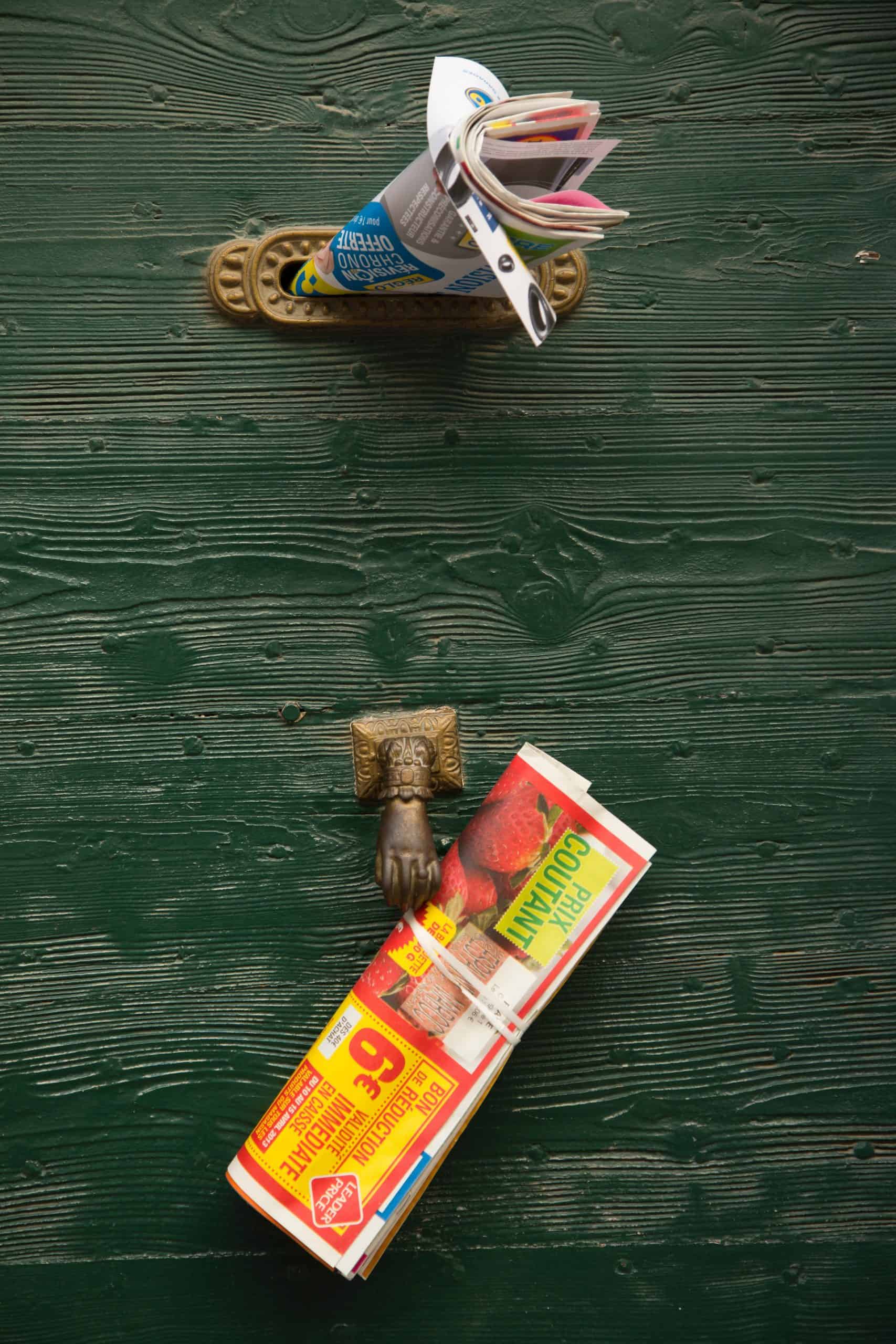 Leaflets in a mail slot of a door