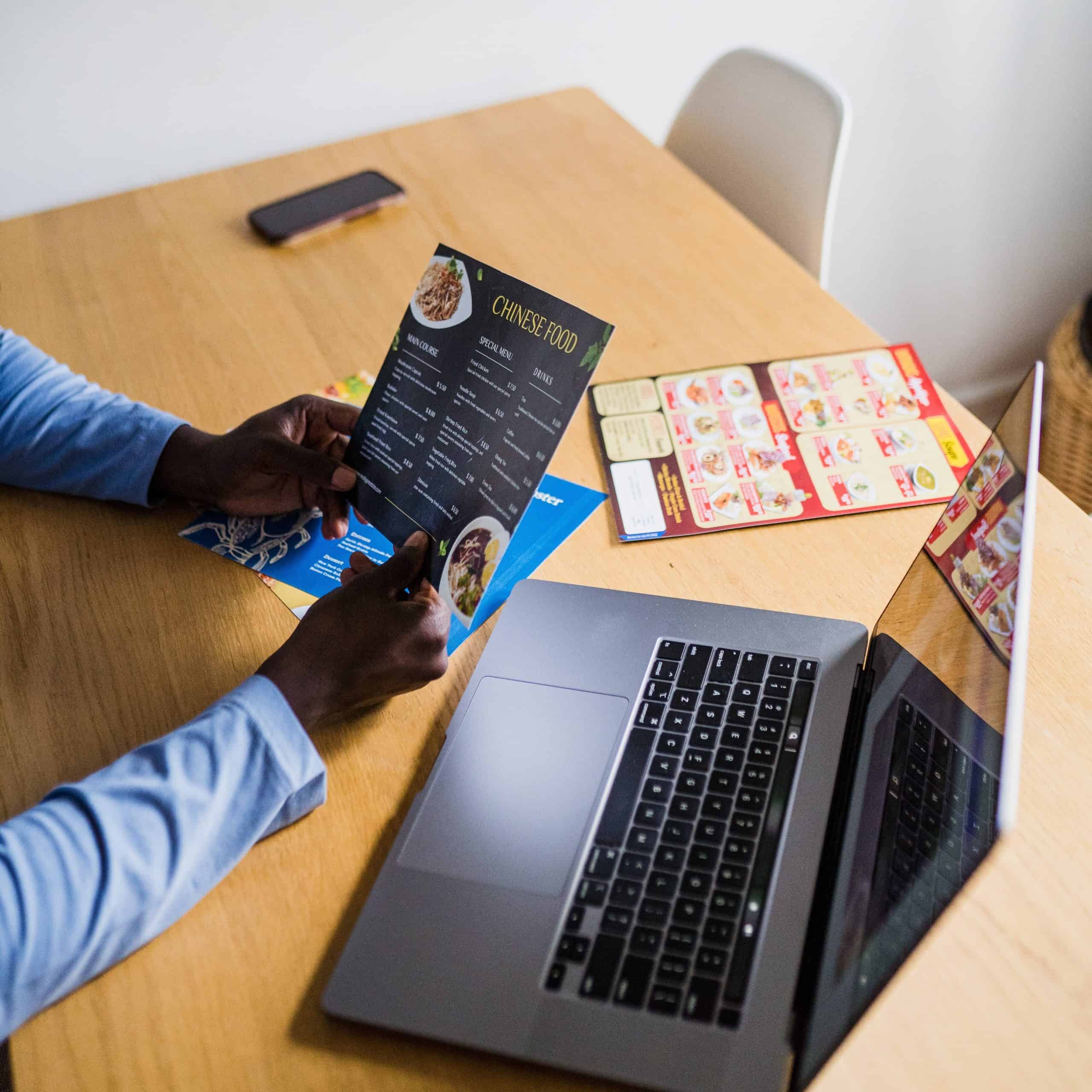 Person holding a leaflet at their desk