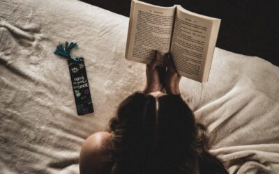 Person reading a book with a custom bookmark text to them