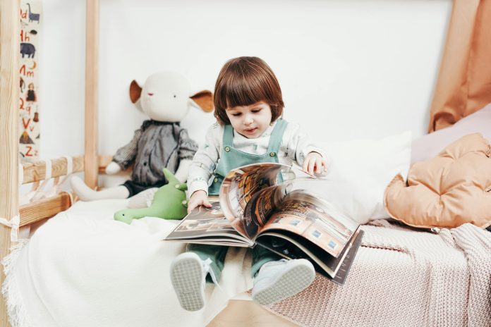 A child opening a hard cover book